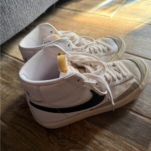 Nike White High-Top Sneakers with Black Swoosh